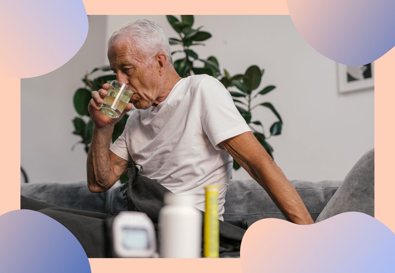 Elderly man drinking water because he has a cold.